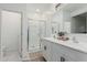 Bright bathroom with a double sink vanity, a glass-enclosed shower, and a separate toilet room at 8715 W Agora Ln, Tolleson, AZ 85353