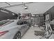 Well-organized garage space with ample storage, a car, and fitness equipment at 8715 W Agora Ln, Tolleson, AZ 85353