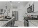 Well-equipped kitchen featuring granite countertops, white cabinets, and stainless steel appliances at 8715 W Agora Ln, Tolleson, AZ 85353