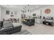 Inviting living room and kitchen with a center island, pendant lights, and stainless steel appliances at 8715 W Agora Ln, Tolleson, AZ 85353