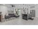 Bright living space with tile floors, modern furnishings, and access to the outdoors through sliding glass doors at 8715 W Agora Ln, Tolleson, AZ 85353