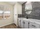 Bright bathroom features a modern vanity, stylish mirror, and gray backsplash at 9710 E Baywood Ave, Mesa, AZ 85208