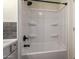 Clean bathroom featuring a shower and bathtub combination with tiled wall accent at 9710 E Baywood Ave, Mesa, AZ 85208