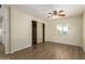Bright bedroom features a ceiling fan, wood-look flooring, and a sliding door closet at 9710 E Baywood Ave, Mesa, AZ 85208