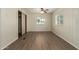 Bedroom features a ceiling fan, wood-look flooring, and two windows at 9710 E Baywood Ave, Mesa, AZ 85208