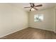 Cozy bedroom features ceiling fan, wood-look flooring, and a sunlit window at 9710 E Baywood Ave, Mesa, AZ 85208