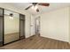 Bright bedroom features a closet with mirrored doors and wood-look flooring at 9710 E Baywood Ave, Mesa, AZ 85208