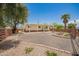 Well-maintained single-story home with a covered porch, desert landscaping, mature trees, and gravel grounds in a quiet neighborhood at 9710 E Baywood Ave, Mesa, AZ 85208