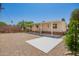 Charming home exterior with a covered patio, neutral paint, and well-kept gravel landscaping at 9710 E Baywood Ave, Mesa, AZ 85208
