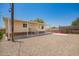 Cozy exterior with covered porch, neutral siding, and well-maintained gravel landscaping at 9710 E Baywood Ave, Mesa, AZ 85208