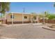 Charming single-story home with a covered porch and landscaped yard, blending comfort and curb appeal in a desert setting at 9710 E Baywood Ave, Mesa, AZ 85208