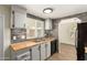Renovated kitchen featuring gray cabinets, wood counters, modern appliances, and subway tile backsplash at 9710 E Baywood Ave, Mesa, AZ 85208