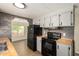 Bright kitchen features stainless steel appliances, butcher block countertops, and stylish gray backsplash at 9710 E Baywood Ave, Mesa, AZ 85208