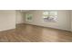 Bright living room featuring wood-look flooring and two large windows for great natural light at 9710 E Baywood Ave, Mesa, AZ 85208