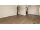 Open living room showcases wood-look floors and neutral wall color at 9710 E Baywood Ave, Mesa, AZ 85208