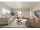 Staged living room with a white sofa and modern decor, bathed in natural light at 9710 E Baywood Ave, Mesa, AZ 85208