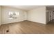 Living room with wood-look flooring, neutral paint, and lots of natural light at 9710 E Baywood Ave, Mesa, AZ 85208
