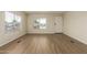 Bright living room featuring wood-look flooring and a large window for great natural light at 9710 E Baywood Ave, Mesa, AZ 85208