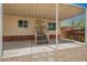 Covered porch with a view of desert landscaping, offering a welcoming outdoor space for relaxation and entertainment at 9710 E Baywood Ave, Mesa, AZ 85208