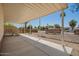 Covered porch leading to a gravel yard, offering seamless transition from indoor living to an inviting outdoor space at 9710 E Baywood Ave, Mesa, AZ 85208