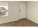 Bright room with vinyl flooring, and white paneled walls, offering a clean canvas for personalization and comfort at 9710 E Baywood Ave, Mesa, AZ 85208