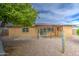 Relaxing backyard showcasing a covered patio with a table and chairs, providing a cozy space for outdoor gatherings at 9710 N 55Th Ave, Glendale, AZ 85302
