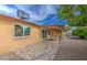 Inviting backyard featuring a covered patio with tiled flooring and a dining set, perfect for outdoor relaxation and entertaining at 9710 N 55Th Ave, Glendale, AZ 85302