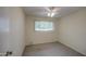 This bedroom features carpet, a window with blinds, a ceiling fan and neutral walls at 9710 N 55Th Ave, Glendale, AZ 85302