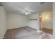 This bedroom includes a ceiling fan, neutral walls, carpet, and backyard access at 9710 N 55Th Ave, Glendale, AZ 85302
