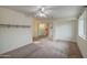 Neutral bedroom with ceiling fan, closet with mirrored doors, and natural light at 9710 N 55Th Ave, Glendale, AZ 85302