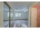 This bedroom includes a ceiling fan, large windows, and a mirrored closet, offering ample natural light at 9710 N 55Th Ave, Glendale, AZ 85302