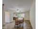 Bright dining room featuring a ceiling fan, tile flooring, and access to the backyard through sliding glass doors at 9710 N 55Th Ave, Glendale, AZ 85302