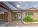 Charming home with stone facade, well-maintained landscaping, and covered entrance at 9710 N 55Th Ave, Glendale, AZ 85302