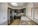 Modern kitchen featuring stainless steel appliances, granite countertops, and ample lighting at 9710 N 55Th Ave, Glendale, AZ 85302