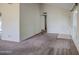 Neutral living space with light walls, carpet flooring, and large door to front at 9710 N 55Th Ave, Glendale, AZ 85302