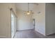 Well-lit living room with a vaulted ceiling, fan, and sliding glass doors at 9710 N 55Th Ave, Glendale, AZ 85302