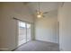 Bright living room with fan, carpet flooring, and door to outdoors at 9710 N 55Th Ave, Glendale, AZ 85302