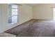 Bright living room with neutral walls, plush carpet, and ample natural light at 9710 N 55Th Ave, Glendale, AZ 85302