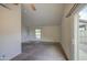 Open-concept living room with carpet, neutral paint, and a glass slider door at 9710 N 55Th Ave, Glendale, AZ 85302