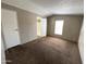Bedroom with neutral walls, carpet flooring, and a doorway to the bathroom at 1002 W Kachina Trl, Phoenix, AZ 85041