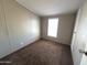 Cozy bedroom featuring neutral walls, plush carpeting, and a bright window at 1002 W Kachina Trl, Phoenix, AZ 85041