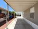 Attached carport offering covered parking and shade, with space for storage or outdoor seating at 1002 W Kachina Trl, Phoenix, AZ 85041