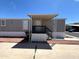 Mobile home featuring an inviting front entrance with a covered porch and desert landscaping at 1002 W Kachina Trl, Phoenix, AZ 85041