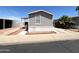 Mobile home featuring desert landscaping, covered parking, and a well-maintained exterior at 1002 W Kachina Trl, Phoenix, AZ 85041