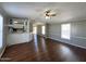 Spacious living room with hard floors, and a ceiling fan with open access to the kitchen at 1002 W Kachina Trl, Phoenix, AZ 85041