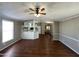 Comfortable living room with hard floors, and a ceiling fan with open access to the kitchen at 1002 W Kachina Trl, Phoenix, AZ 85041