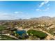 Panoramic aerial view of the golf course community and landscape, featuring a serene pond at 10527 E Acacia Dr, Scottsdale, AZ 85255