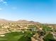 Expansive aerial view of golf course and residential area, capturing the community's landscape at 10527 E Acacia Dr, Scottsdale, AZ 85255