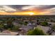 Stunning aerial view of a neighborhood at sunset, showcasing a Primary-planned community with beautiful homes and landscaping at 10527 E Acacia Dr, Scottsdale, AZ 85255