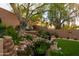 Secluded backyard featuring a stone staircase and lush greenery creating a tranquil oasis at 10527 E Acacia Dr, Scottsdale, AZ 85255